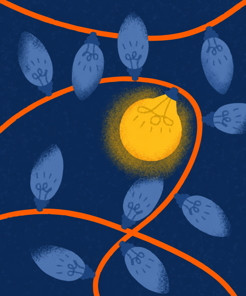 One lit golden bulb among a string of unlit bulbs